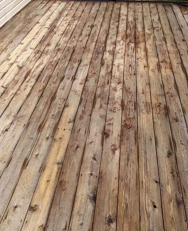 Deck boards after cleaning, back to bare tan wood with the grain showing