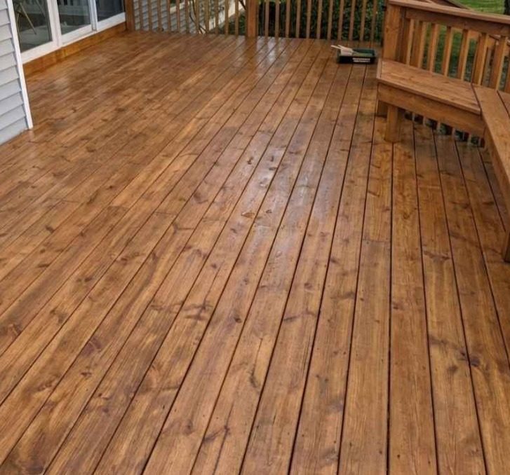 The same deck after stripping and refinishing in a warm brown stain, same bench and sliding doors
